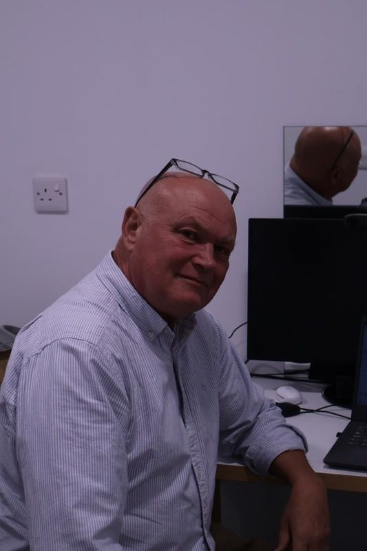 An optometrist at the consulting-room desk at Millicans and Mansfield, Wells
